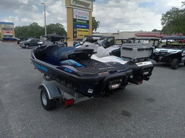 Slide: The Image of 2025 Sea-Doo Waverunner FISH PRO on trailer at dealership, surrounded by other vehicles. - 15