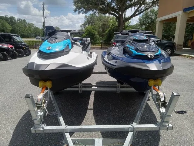 Slide: The Image of 2025 Sea-Doo Waverunner FISH PRO models on a trailer, parked outdoors. - 5