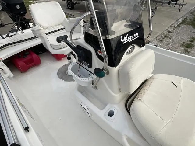 Slide: The Image of 2012 Mako Pro Skiff boat interior with steering console and white seating. - 11