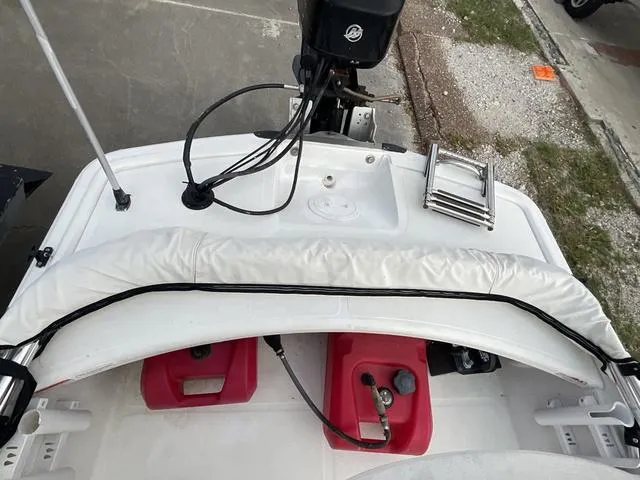 Slide: The Image of 2012 Mako Pro Skiff boat deck with motor, ladder, and red fuel tanks. - 14