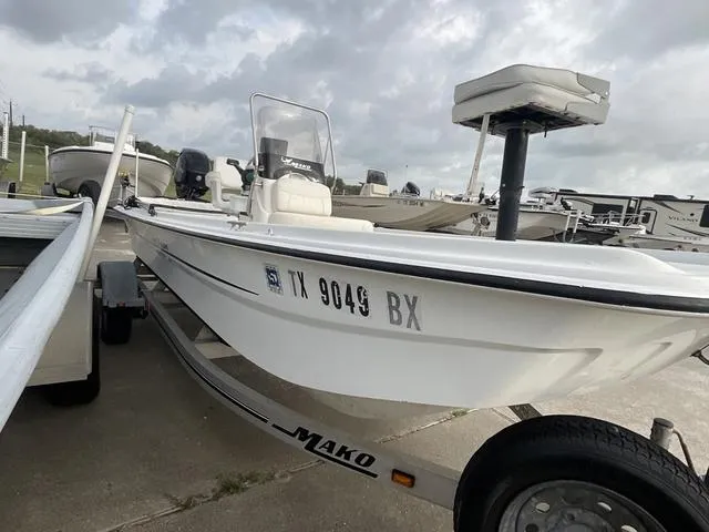 Slide: The Image of 2012 Mako Pro Skiff boat on trailer, parked outdoors under cloudy sky. - 3
