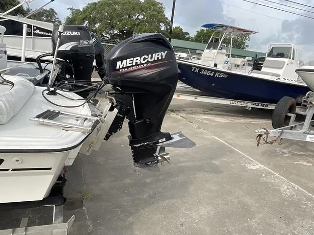 Slide: The Image of 2012 Mako Pro Skiff with Mercury outboard motor in a boatyard. - 4