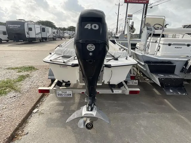 Slide: The Image of 2012 Mako Pro Skiff with 40 HP outboard motor on trailer, parked outdoors. - 5