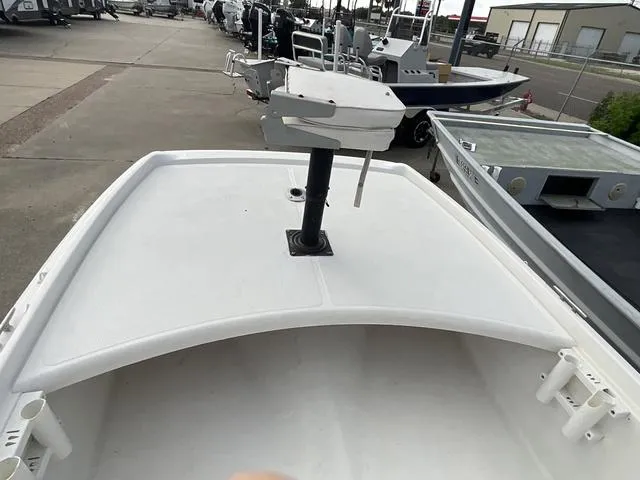 Slide: The Image of 2012 Mako Pro Skiff boat deck with mounted equipment, docked in a marina. - 7