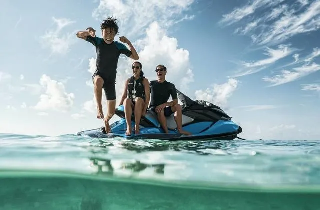 Slide: The Image of Three people enjoying a 2018 Sea-Doo Waverunner GTI on a sunny day. - 3