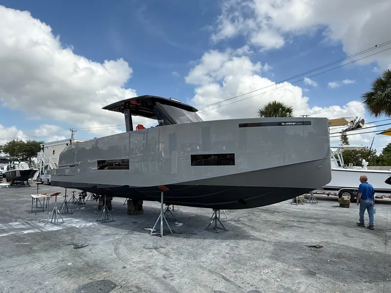 The Image of 2021 De Antonio Yachts D42 on dry dock under a partly cloudy sky. - 0