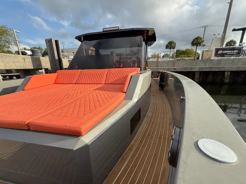 Slide: The Image of 2021 De Antonio Yachts D42 with orange sunbed, docked in a marina. - 10