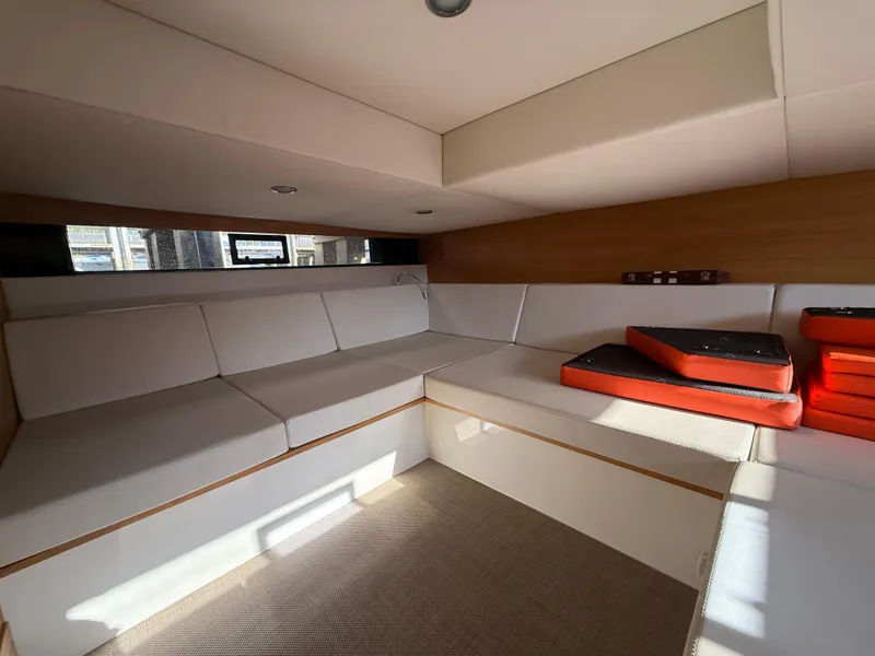 Slide: The Image of Interior of 2021 De Antonio Yachts D42, featuring modern seating and cushions. - 14