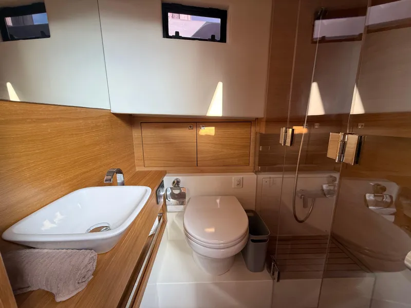 Slide: The Image of Luxurious bathroom in 2021 De Antonio Yachts D42, featuring modern fixtures and wooden accents. - 16