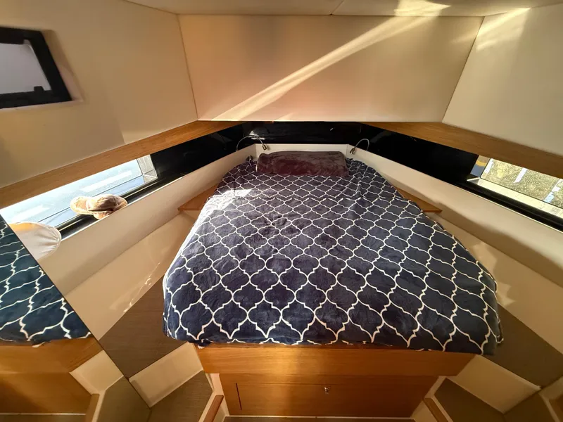 Slide: The Image of Cozy cabin interior of 2021 De Antonio Yachts D42 with patterned bedding. - 18