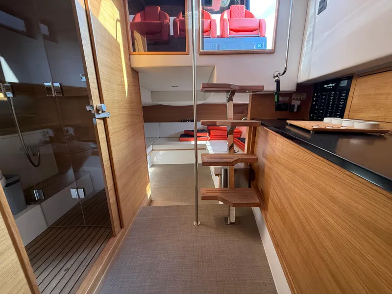 Slide: The Image of Interior of 2021 De Antonio Yachts D42, featuring modern wood finishes and compact design. - 20