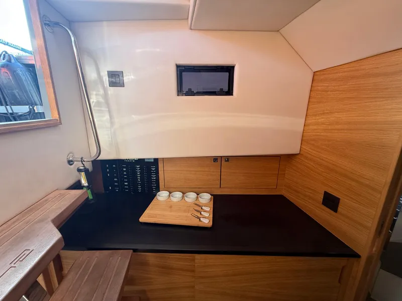 Slide: The Image of Interior of 2021 De Antonio Yachts D42, featuring a sleek wooden kitchenette. - 21