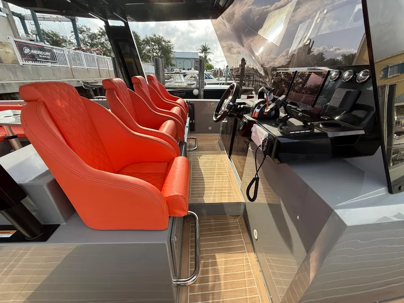 Slide: The Image of Interior of 2021 De Antonio Yachts D42 with red seats and modern dashboard. - 7