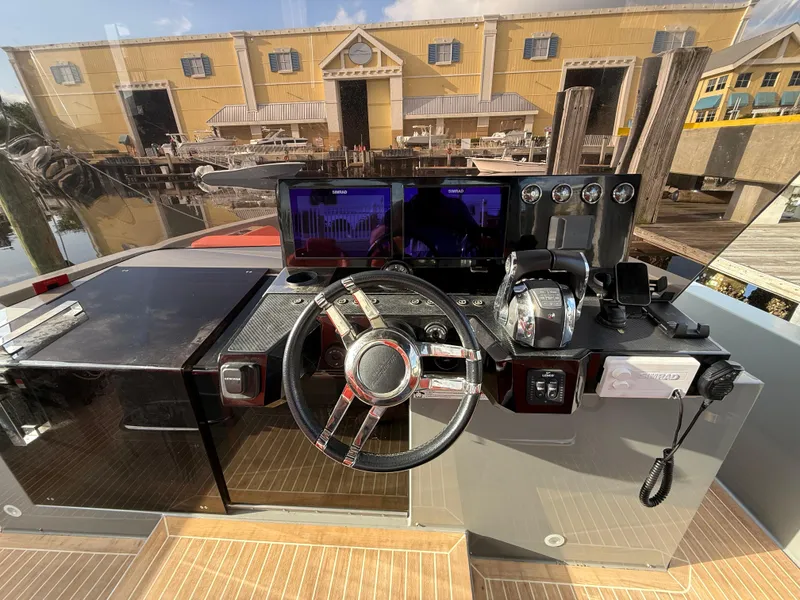 Slide: The Image of Helm of 2021 De Antonio Yachts D42 with modern controls and waterfront view. - 8