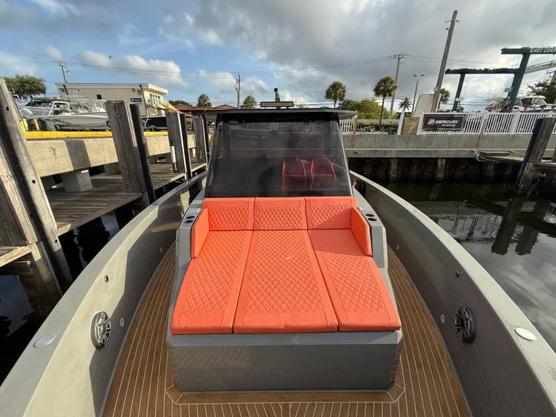 Slide: The Image of De Antonio Yachts D42, 2021 model, featuring orange deck seating at a marina. - 9