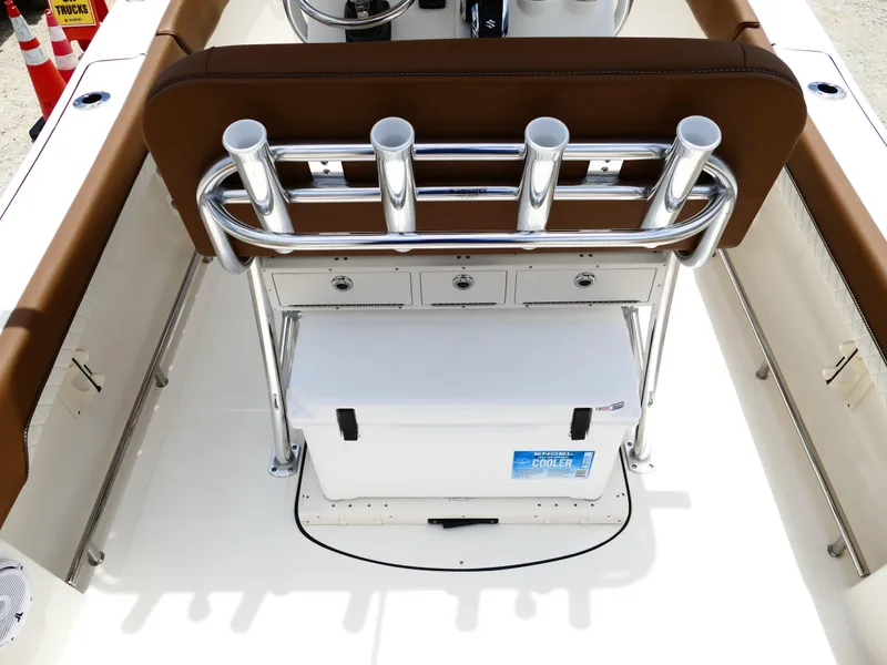 Slide: The Image of 2026 Pioneer 202 Islander boat interior with rod holders and cooler storage. - 12