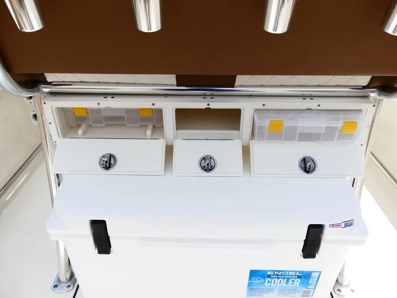 Slide: The Image of 2026 Pioneer 202 Islander boat storage compartments with Engel cooler and rod holders. - 19