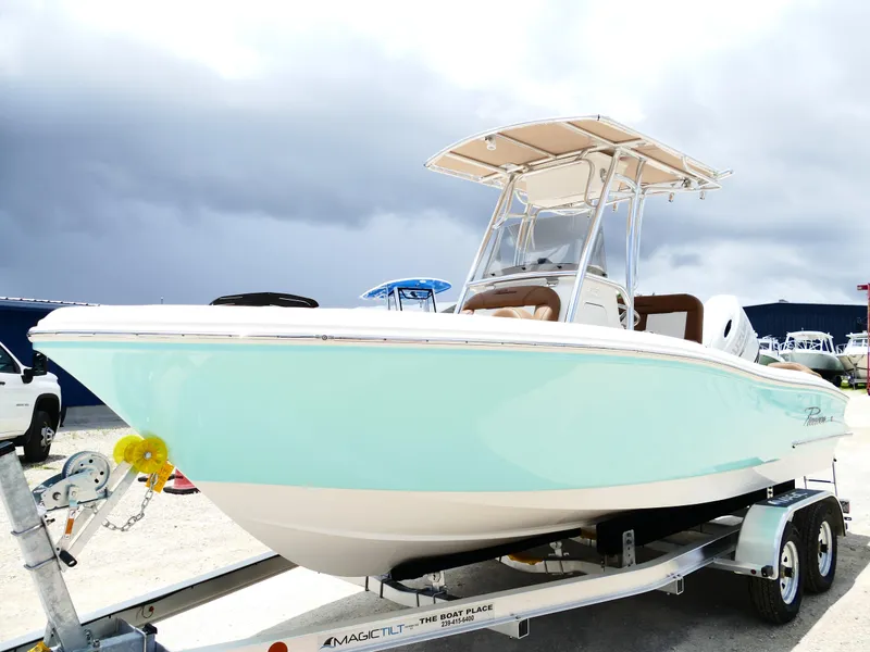 Slide: The Image of 2026 Pioneer 202 Islander boat on trailer, light blue hull, overcast sky background. - 2