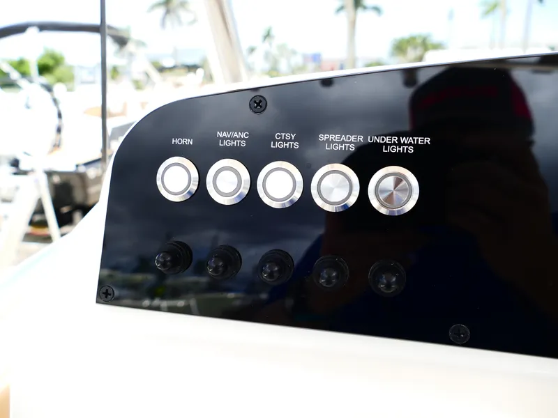 Slide: The Image of Control panel of 2026 Pioneer 202 Islander boat with labeled buttons for lights and horn. - 25