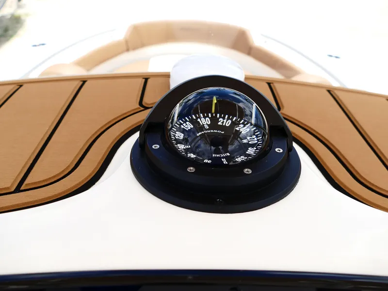 Slide: The Image of Compass on 2026 Pioneer 202 Islander boat with wooden deck detail. - 26