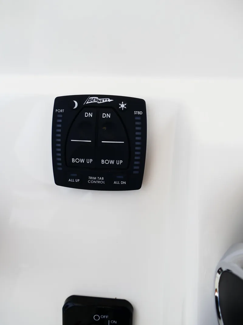 Slide: The Image of Bennett trim tab control panel on 2026 Pioneer 202 Islander boat. - 27