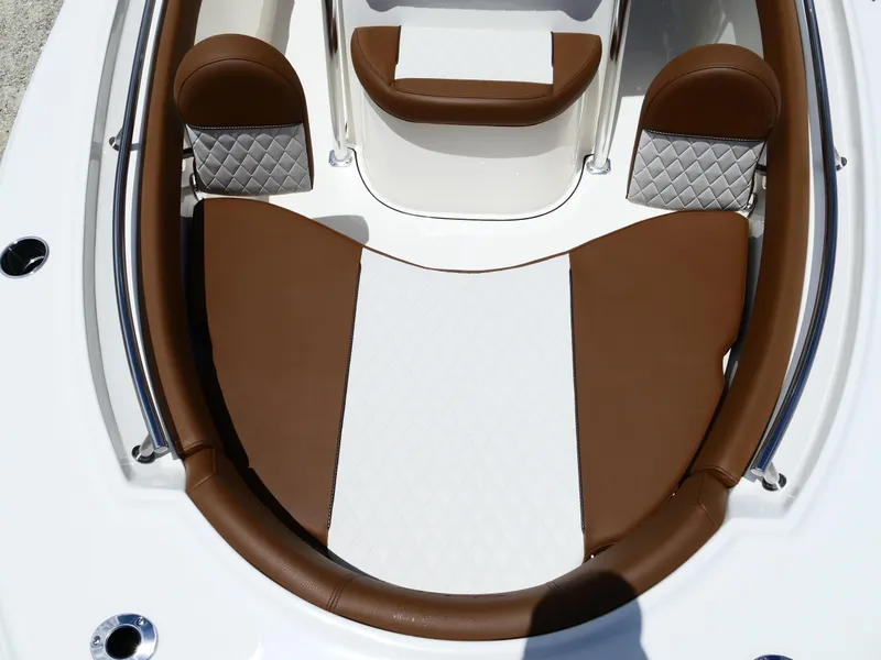 Slide: The Image of 2026 Pioneer 202 Islander boat interior with brown and white cushioned seating. - 37