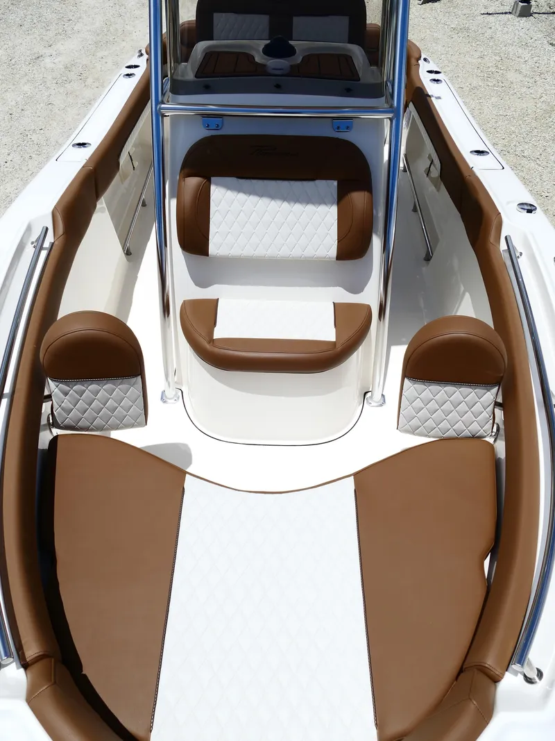 Slide: The Image of 2026 Pioneer 202 Islander boat interior with brown and white cushioned seating. - 38