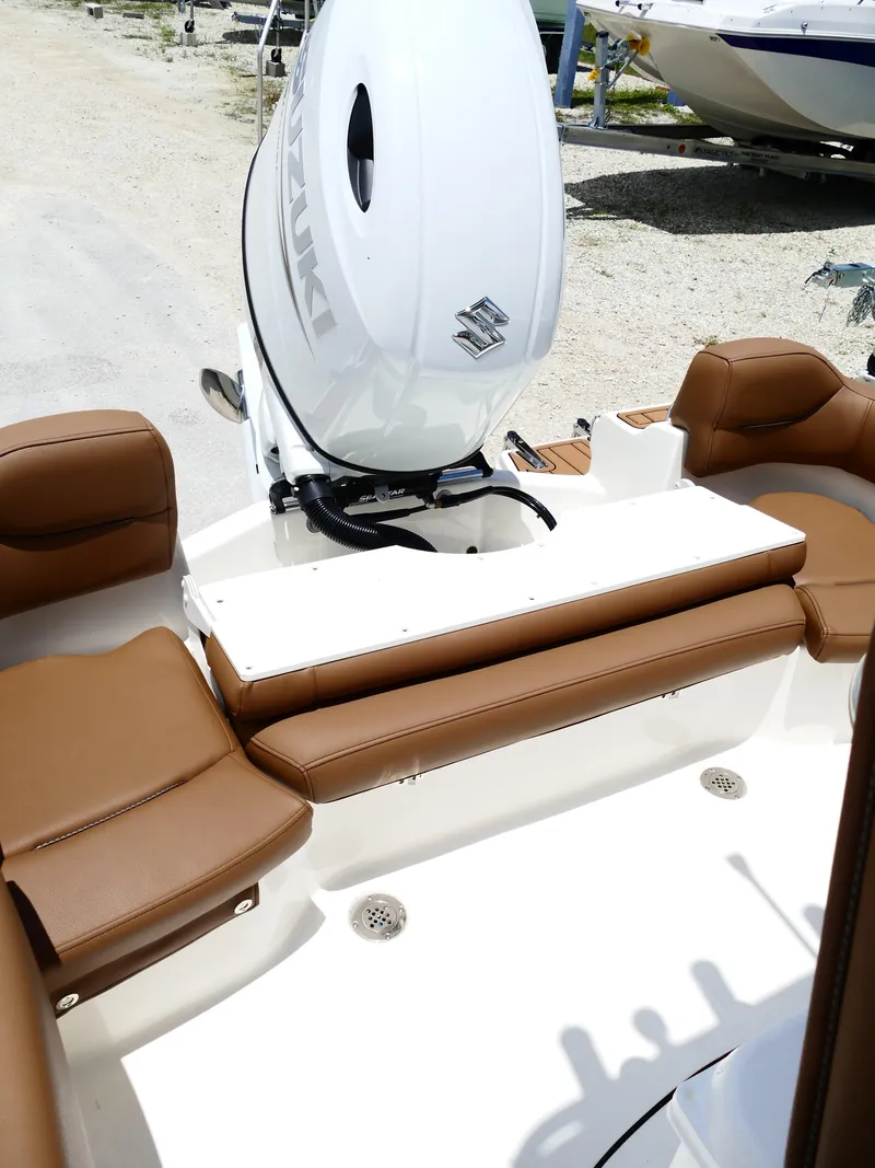 Slide: The Image of 2026 Pioneer 202 Islander boat interior with brown seating and Suzuki outboard motor. - 47