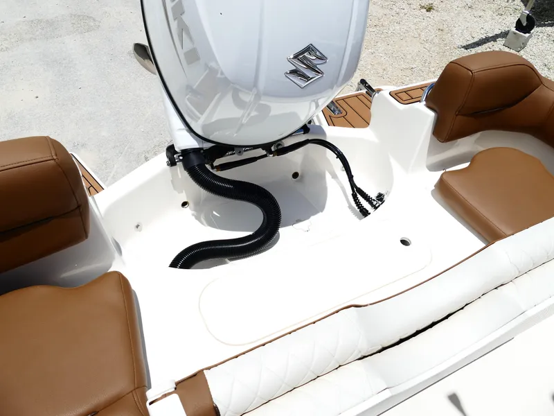 Slide: The Image of 2026 Pioneer 202 Islander boat interior with brown seating and Suzuki outboard motor. - 49