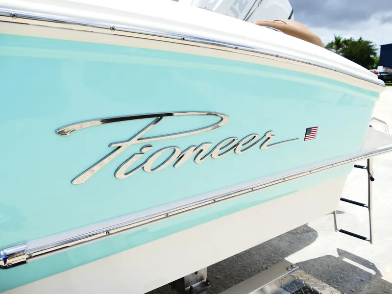 Slide: The Image of 2026 Pioneer 202 Islander boat with sleek design and American flag emblem. - 5