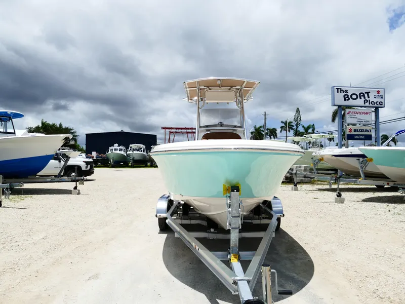Slide: The Image of 2026 Pioneer 202 Islander boat on trailer at dealership under cloudy sky. - 6