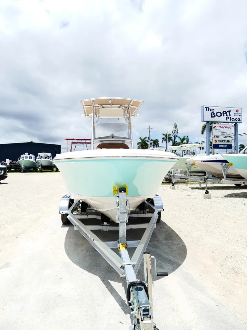 Slide: The Image of 2026 Pioneer 202 Islander boat on trailer at dealership under cloudy sky. - 7