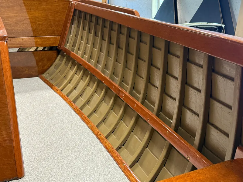 Slide: The Image of 1955 Lyman 18 Inboard boat interior with wooden detailing and ribbed design. - 13