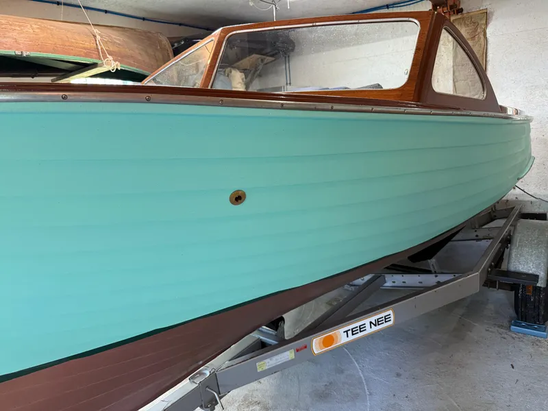 Slide: The Image of 1955 Lyman 18 Inboard boat with teal hull on Tee Nee trailer. - 2