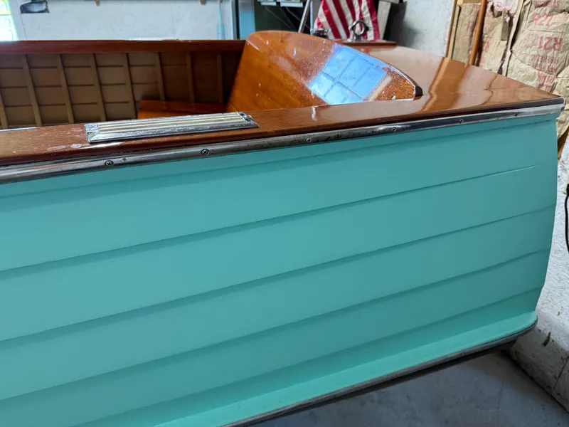 Slide: The Image of 1955 Lyman 18 Inboard boat with turquoise exterior and polished wood interior. - 3