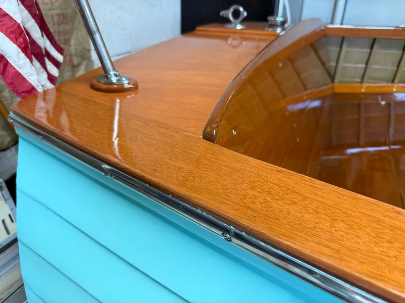 Slide: The Image of 1955 Lyman 18 Inboard boat with polished wood and turquoise exterior. - 4