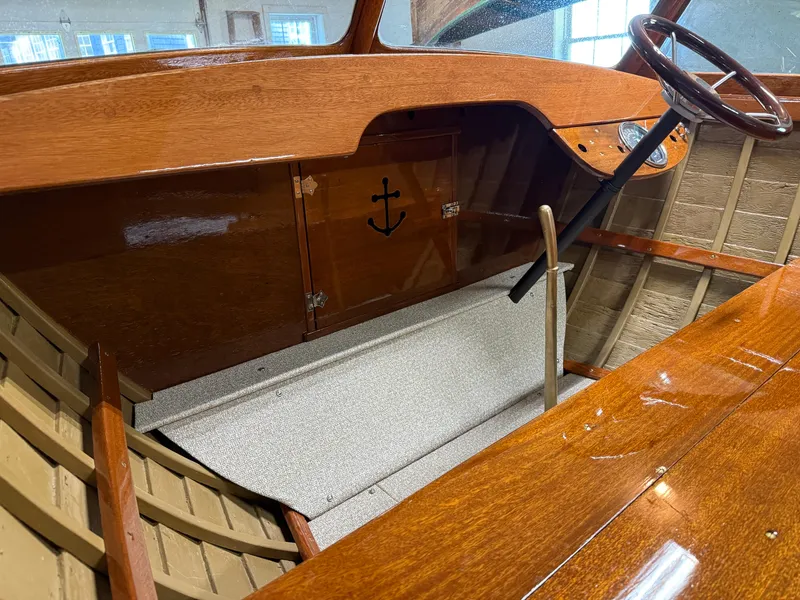 Slide: The Image of 1955 Lyman 18 Inboard boat interior with wooden dashboard and steering wheel. - 7