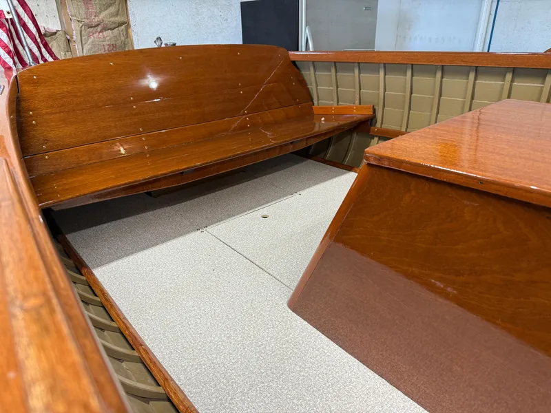 Slide: The Image of 1955 Lyman 18 Inboard boat interior with polished wooden seats and flooring. - 8