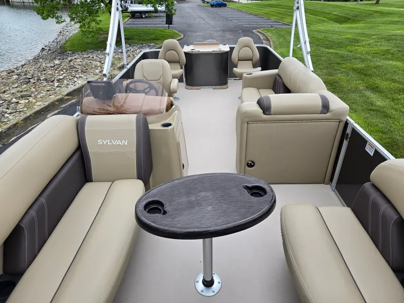 Slide: The Image of 2022 Sylvan Mirage Fish 822 Party Fish pontoon boat with beige seating and table. - 11