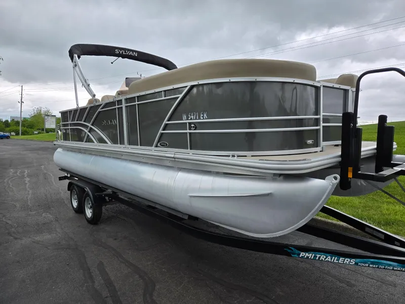 Slide: The Image of 2022 Sylvan Mirage Fish 822 Party Fish pontoon boat on trailer, overcast sky. - 5