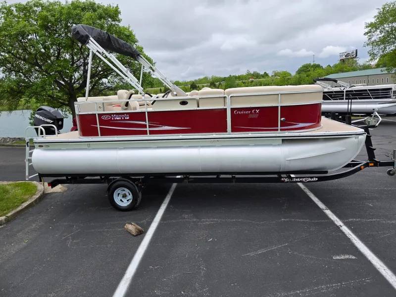 Slide: The Image of 2010 Harris FloteBote 200 Cruiser CX pontoon boat on trailer, parked outdoors. - 10