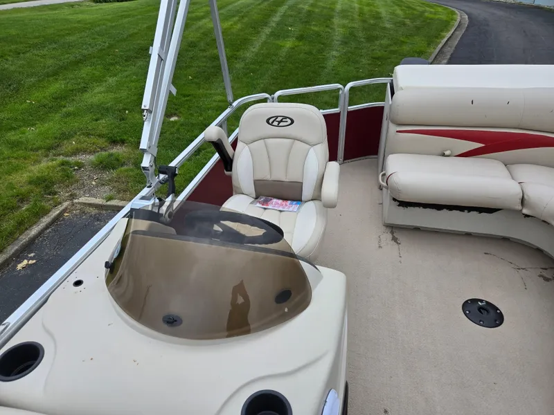 Slide: The Image of 2010 Harris FloteBote 200 Cruiser CX interior with seating and steering console. - 13