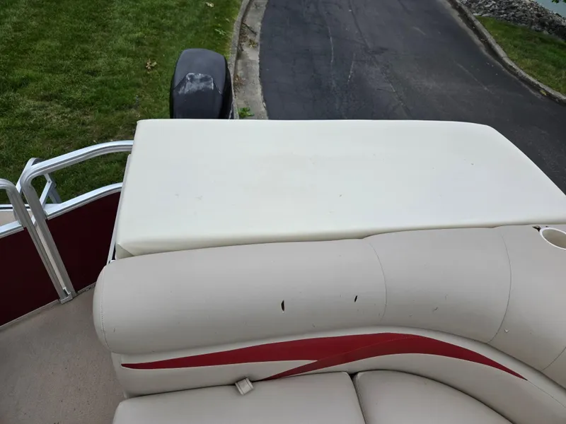 Slide: The Image of 2010 Harris FloteBote 200 Cruiser CX boat interior with beige seating and red accents. - 15