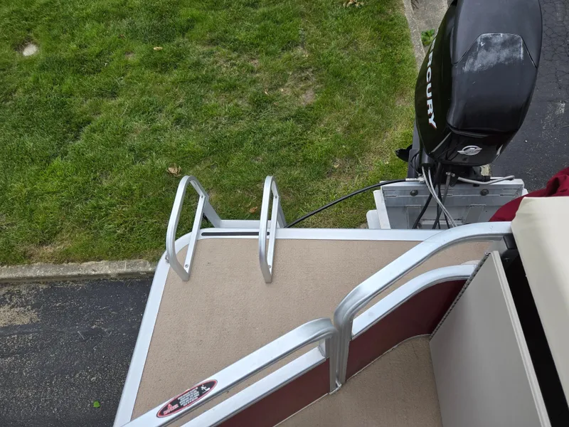 Slide: The Image of 2010 Harris FloteBote 200 Cruiser CX boat with ladder and Mercury outboard motor. - 16