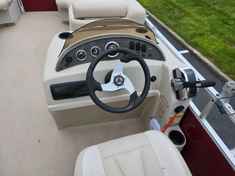 Slide: The Image of 2010 Harris FloteBote 200 Cruiser CX boat dashboard with steering wheel and controls. - 21