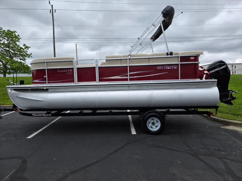 Slide: The Image of 2010 Harris FloteBote 200 Cruiser CX pontoon boat on trailer, parked outdoors. - 4