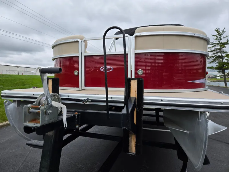 Slide: The Image of 2010 Harris FloteBote 200 Cruiser CX pontoon boat on trailer, red and beige exterior. - 6