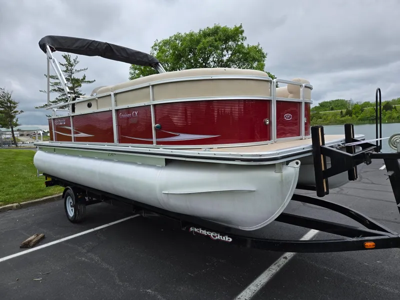 Slide: The Image of 2010 Harris FloteBote 200 Cruiser CX pontoon boat on trailer in parking lot. - 9