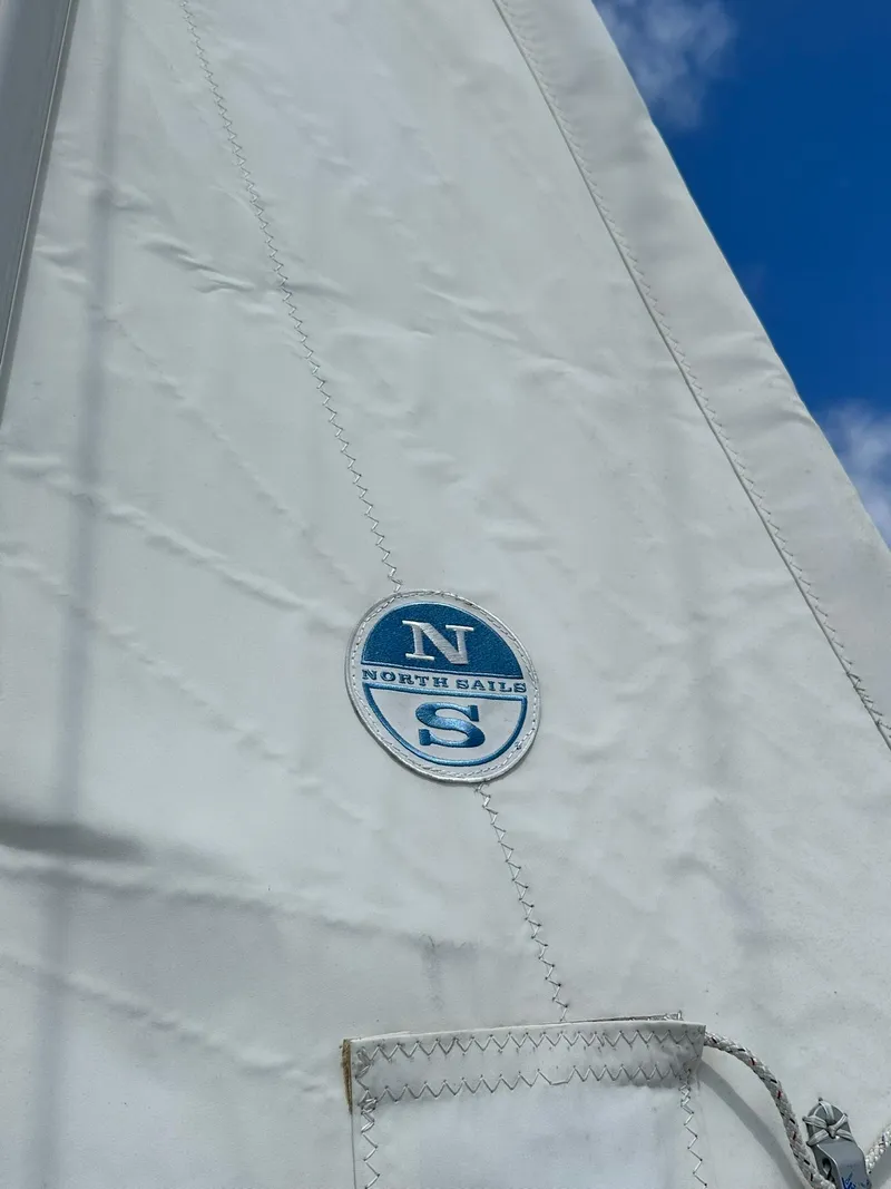 Slide: The Image of Sail of Jeanneau Sun Odyssey 45 DS 2011 with North Sails logo against blue sky. - 10