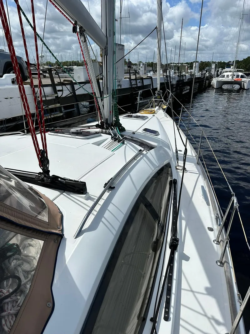 Slide: The Image of 2011 Jeanneau Sun Odyssey 45 DS sailboat docked at marina under cloudy sky. - 13